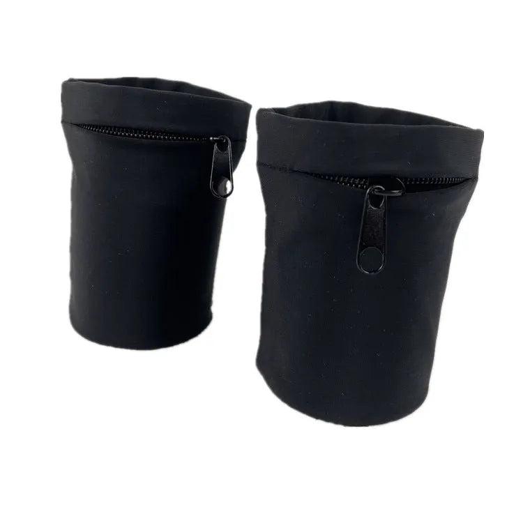 Black adjustable wrist bag with armband, showing zipped main compartment and external card slot on a person's forearm.