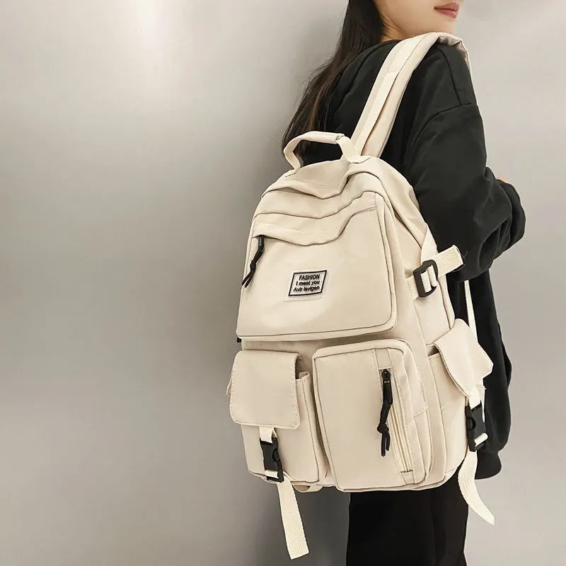 Black or white nylon student backpack with computer compartment and three-dimensional pockets