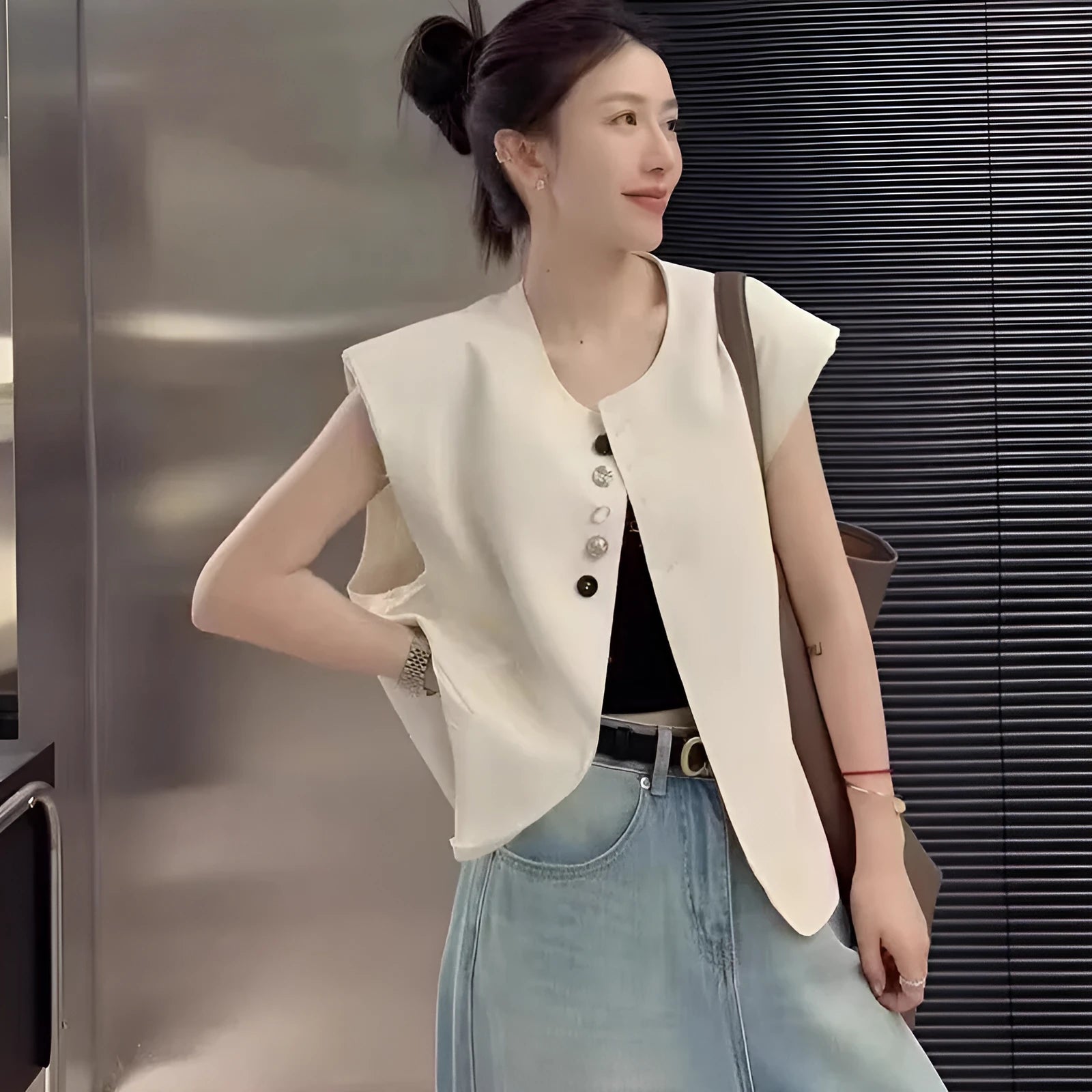 Women's loose fit polyester vest in milky white with pockets, shown on a hanger.