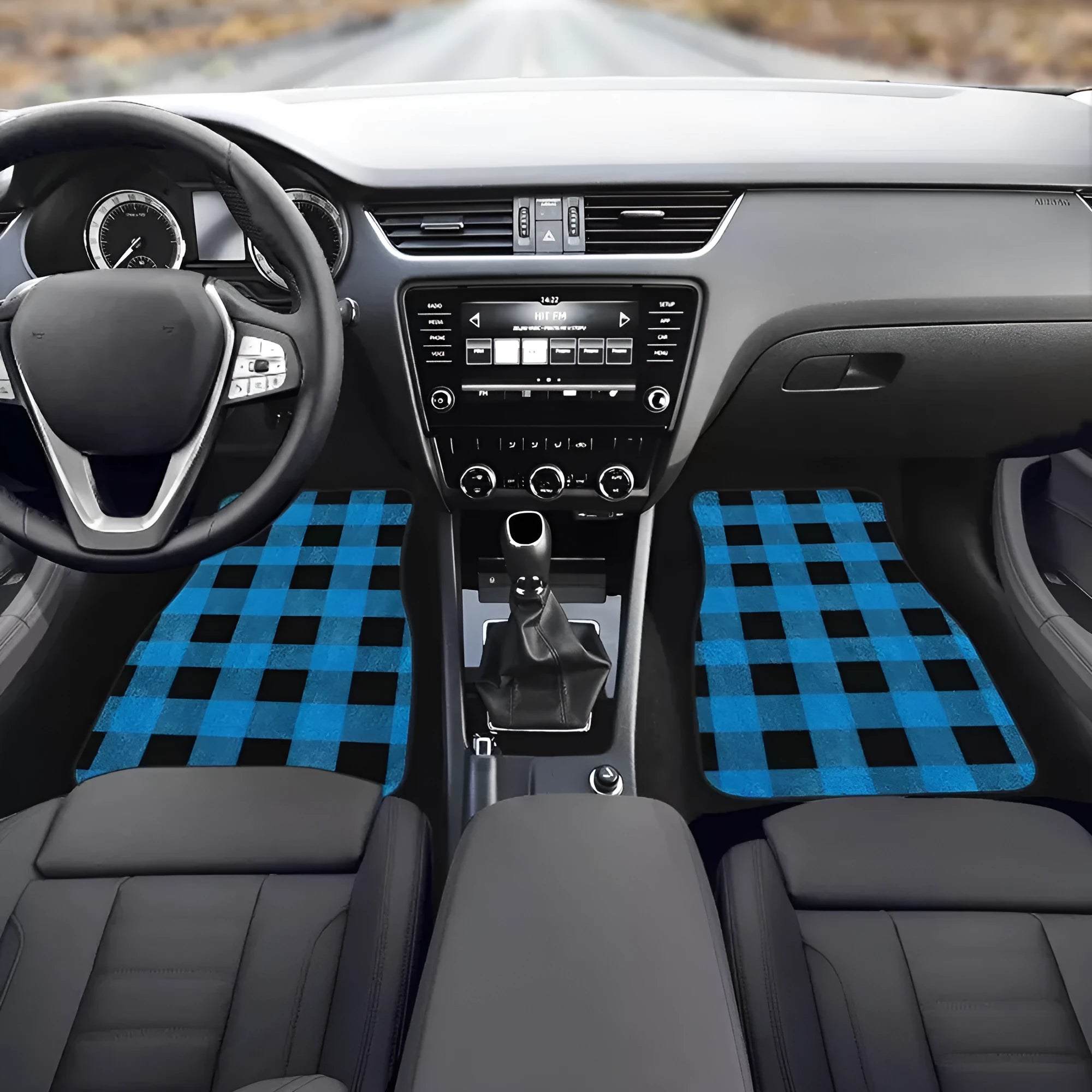 Set of four black rubber car floor mats with a textured surface, shown in a vehicle footwell.