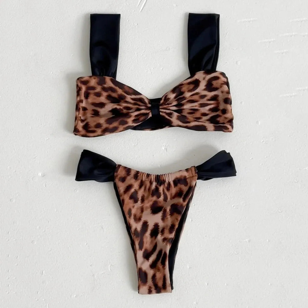 Women's black and leopard print tube top bikini set laid flat, showing the sleeveless top and briefs.