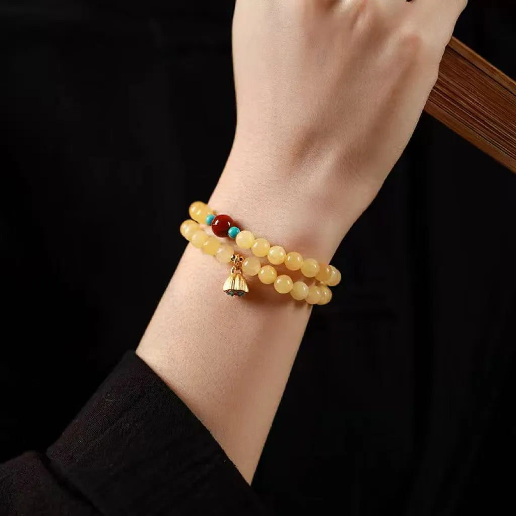 Handmade yellow jade double ring bracelet for women on a wrist, showing 6mm and 8mm size options.
