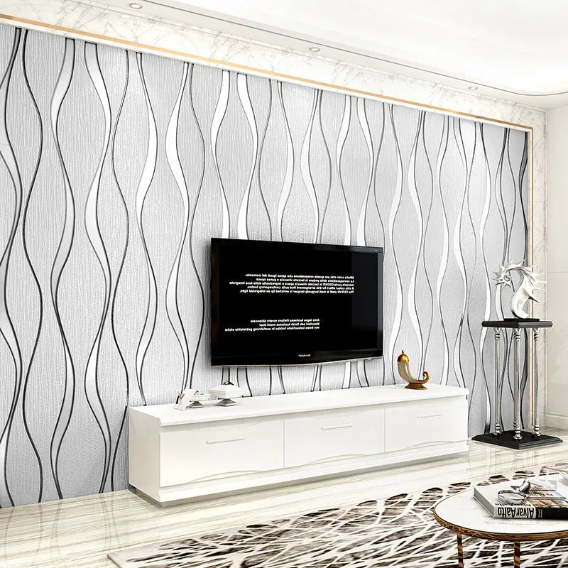 Roll of grey 3D stripe wallpaper with thick velvet texture next to a sample on a wall