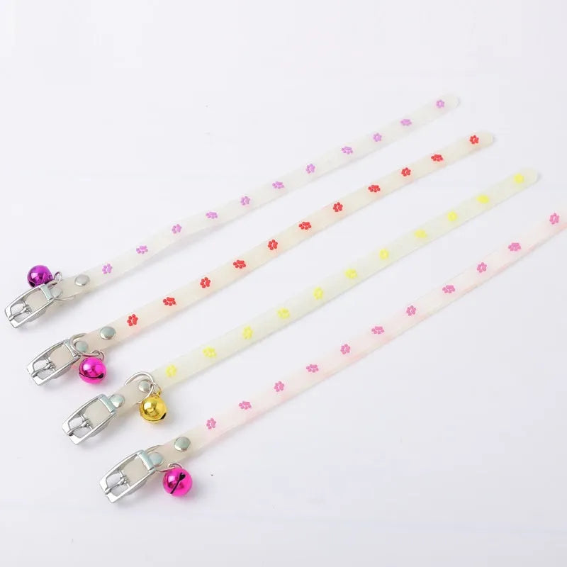 Luminous cat collar with glowing effect, silicone chain, metal bell, in a paw print pattern design.