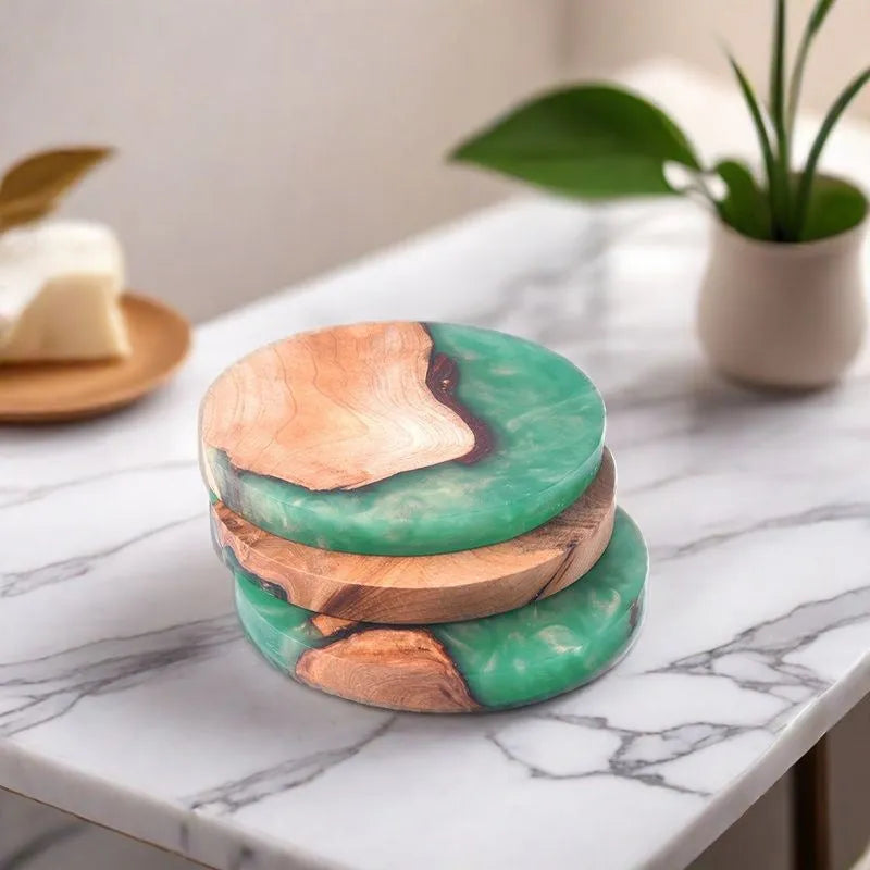 Solid colour resin coaster on a wooden table next to a mug, showing round tumour green and black options.