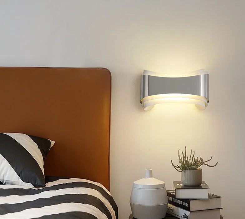 Modern LED wall lamp with warm white light, 23cm wide by 13cm high with matte finish