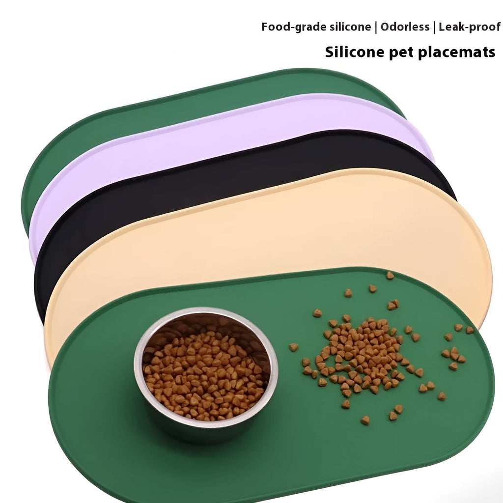 Beige silicone cat feeding mat with raised edges holding a food and water bowl on a wooden floor.
