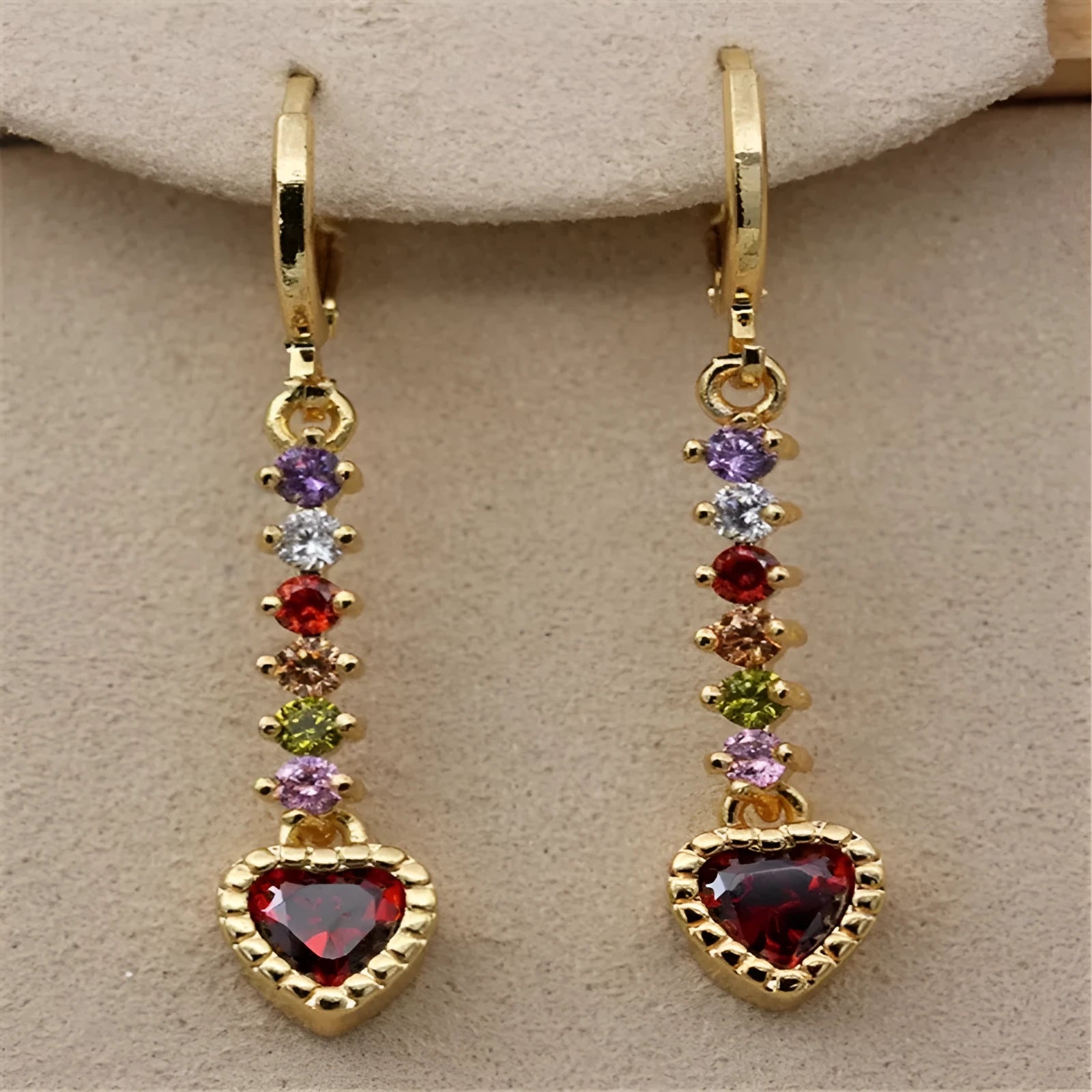 A pair of women's heart-shaped earrings with an electroplated gold or silver finish on an alloy base.
