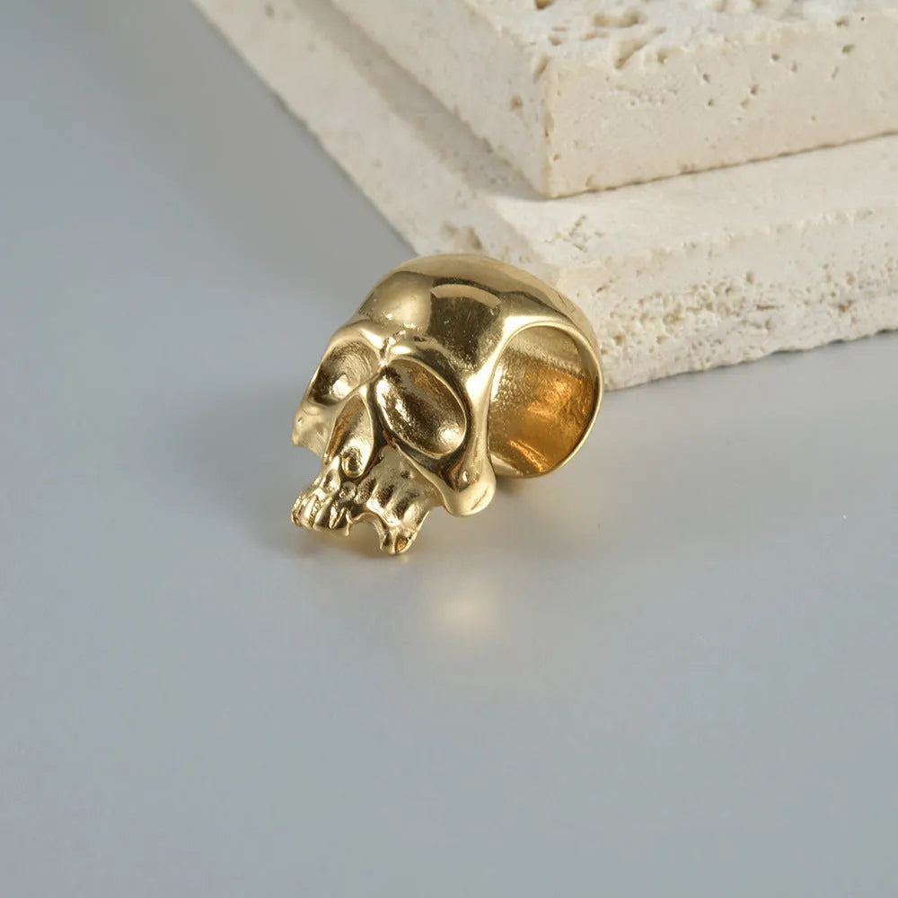 Stainless steel hollow skull Buddha earring in geometric hip hop style.