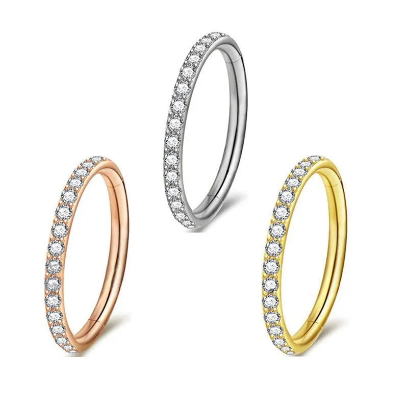 Seamless stainless steel nose ring with a central diamond decoration, shown in gold and rose gold finishes.