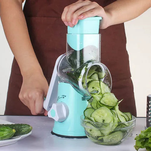 Blue round manual mandoline slicer with stainless steel blade for vegetables on a kitchen counter.