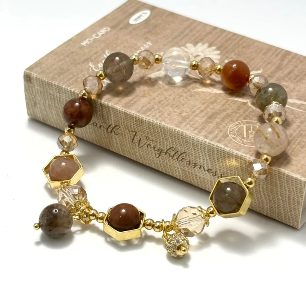 Gold citrine crystal bracelet with Fu character, safety lock, and cloud pattern charms on wrist