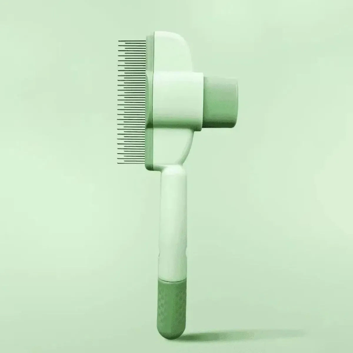 Green pet grooming brush with one-click hair removal system and soft rubber bristles for dogs