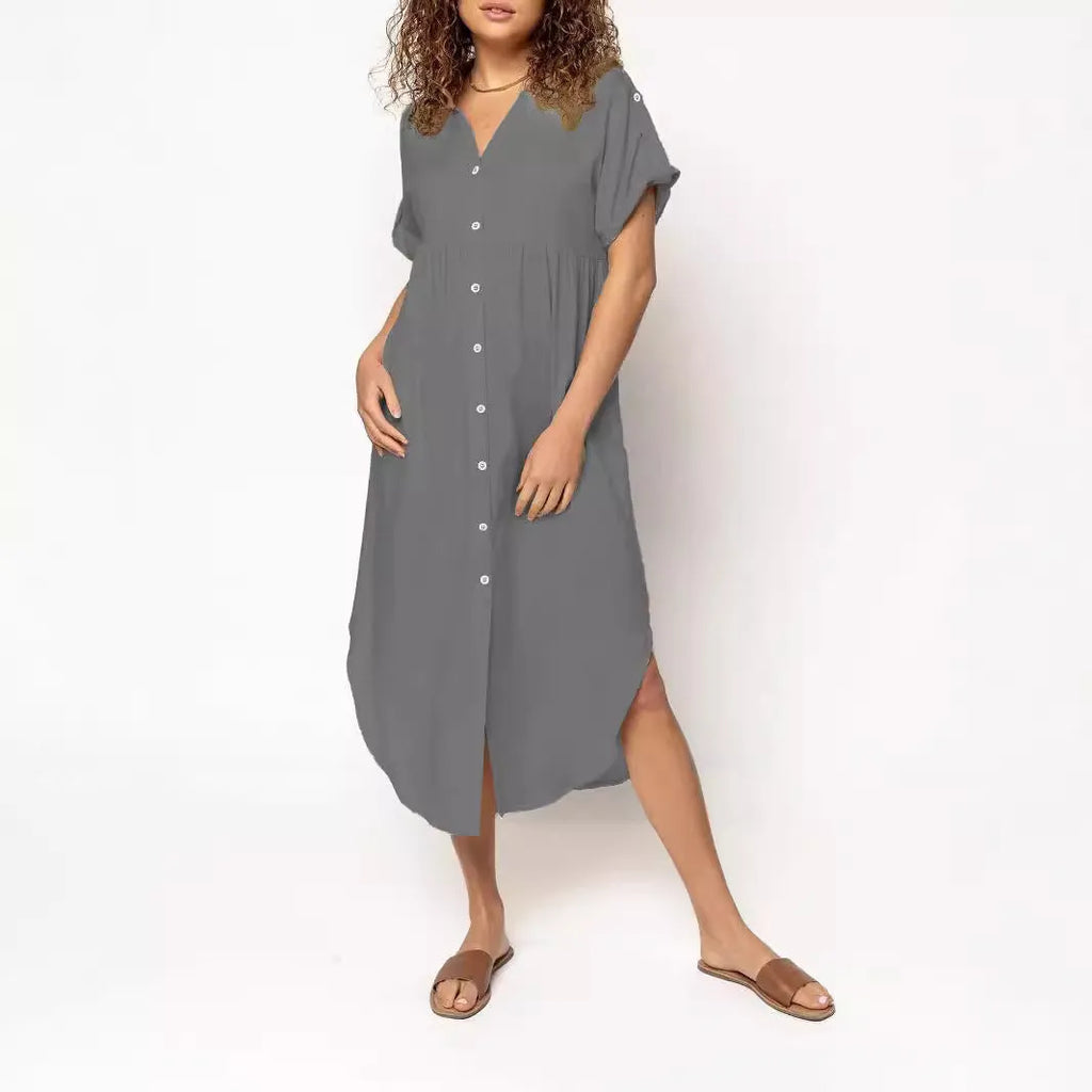 Loose-fitting mid-length casual dress with button front detail on a hanger.