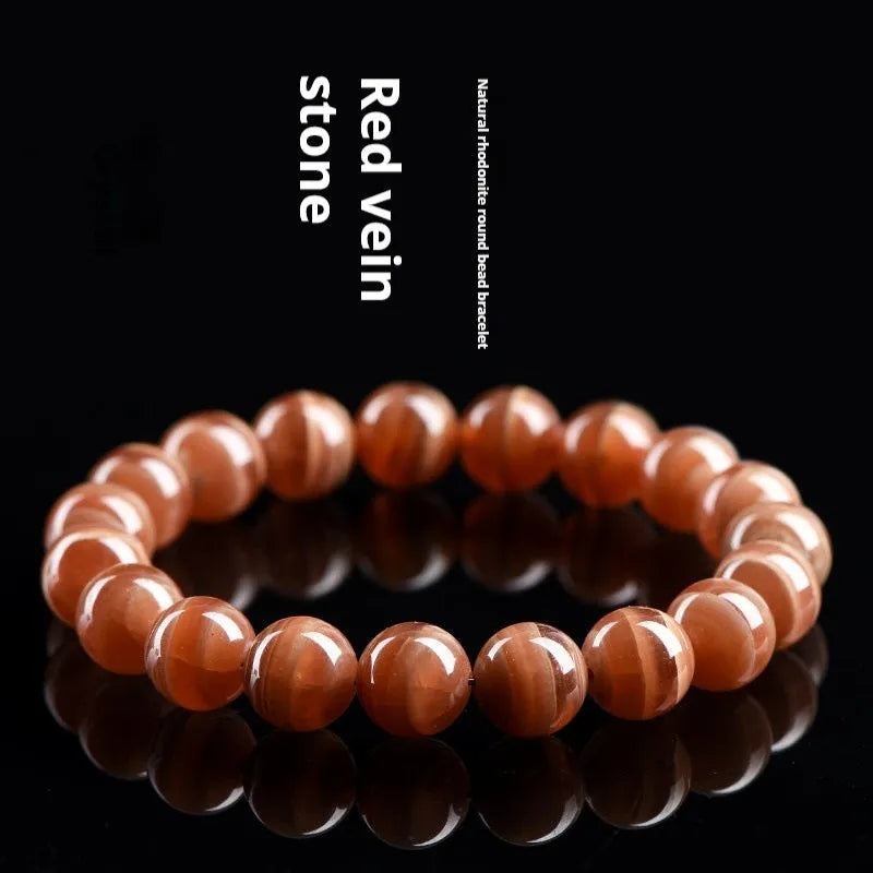 Natural old mine rhodochrosite round bead bracelet from Peru with ruyi charms.