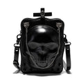 Black mini square crossbody bag with embossed skull design, metal rivets, chain strap, and top zipper.