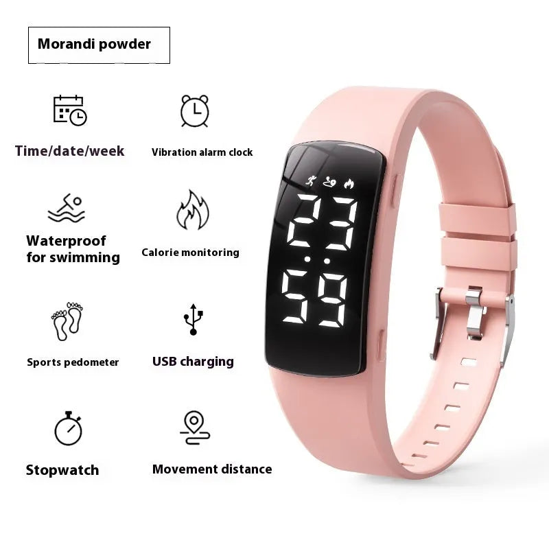 Black electronic digital watch with LED display and silicone strap on a wrist.