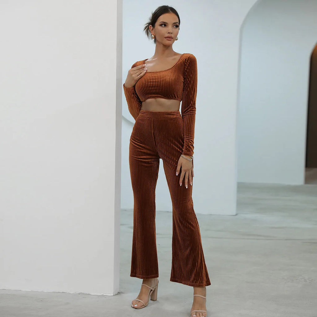 Caramel coloured women's long sleeve sweater and matching straight-leg trousers set on a hanger.