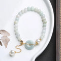 Natural jade peace buckle pearl bracelet with geometric pendant on wrist