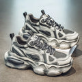 Men's black and white low-top mesh sneakers with a platform sole and lace-up front.