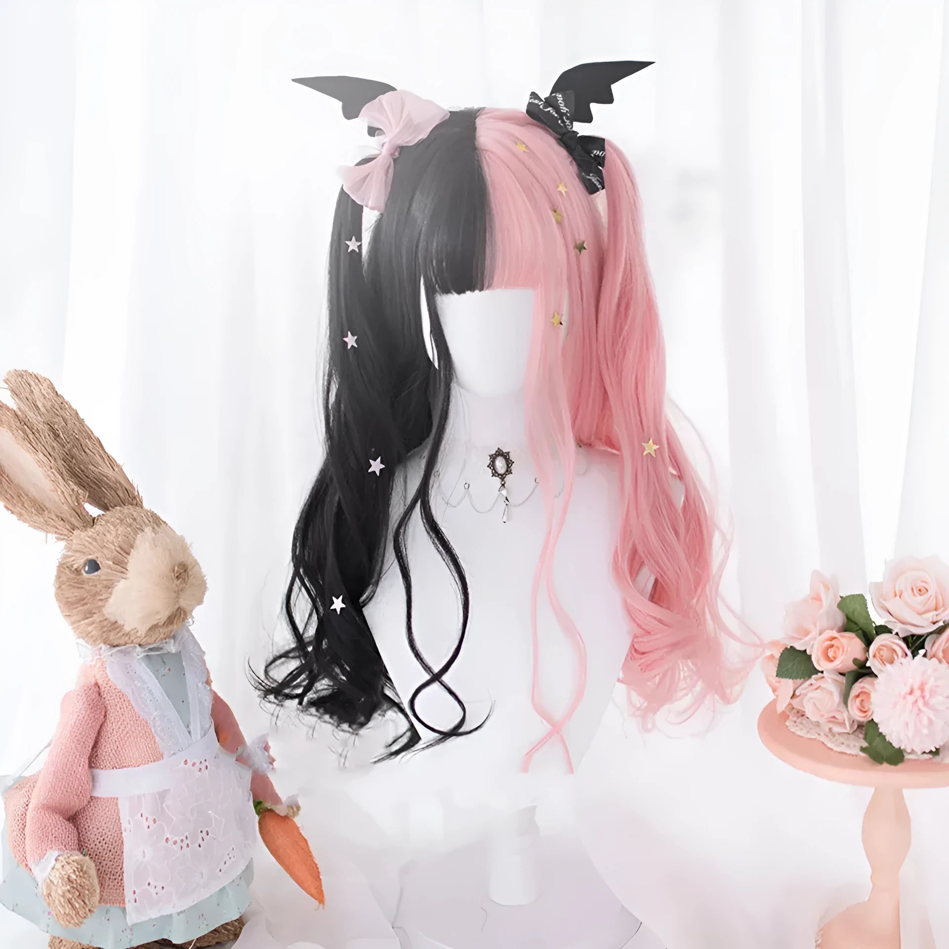 Long curly black and pink Lolita cosplay wig with a fringe on a display head.