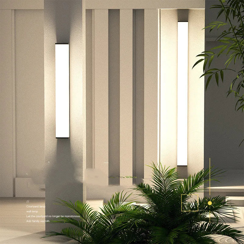 Stainless steel long strip outdoor wall light with LED, mounted on an exterior wall.