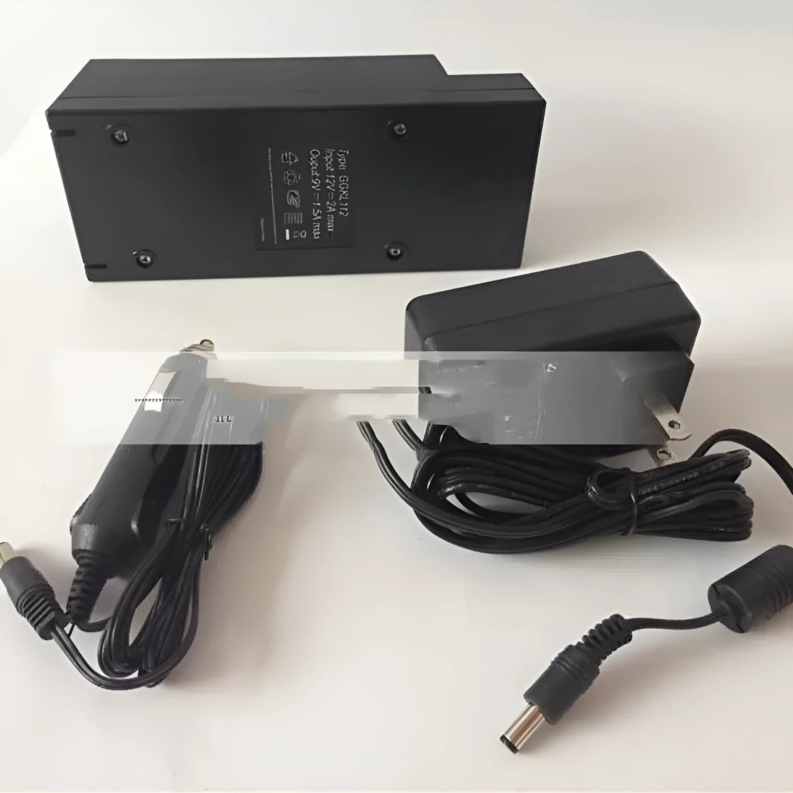 GKL112 model compact white 220V car charger with US plug on a wooden workbench.