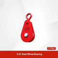Red industrial single sheave lifting pulley with a safety latch on the steel hook.