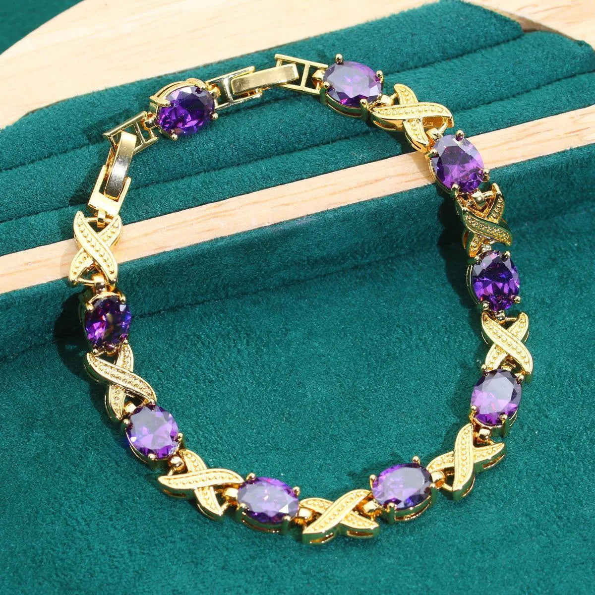 An 18k gold plated jewellery set featuring a necklace, earrings, a ring, and a bracelet with coloured cubic zirconia stones.