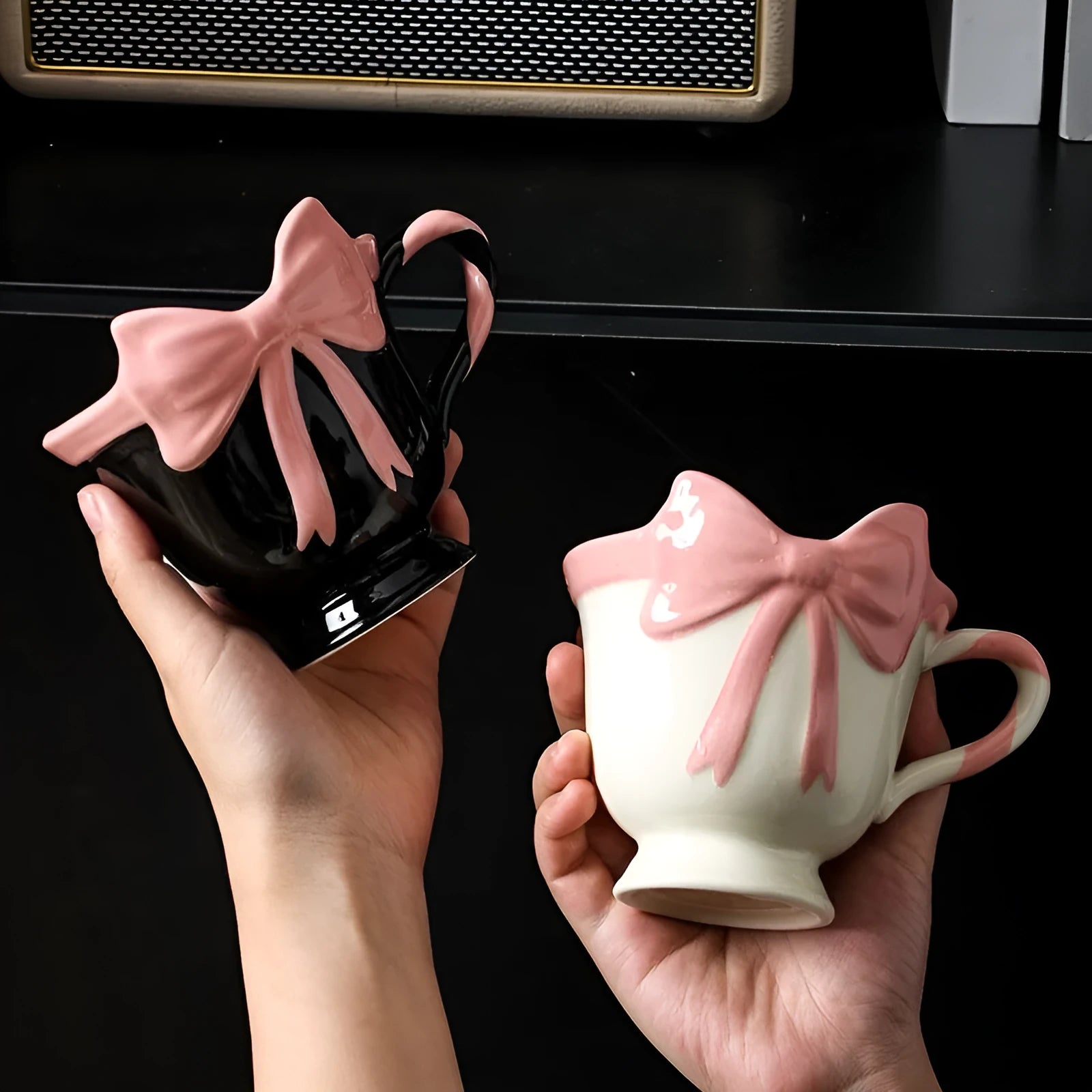 Ceramic mug with heart bow design in white powder and black pink colours.