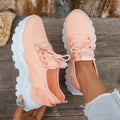 Women's white Flyknit mesh casual sports shoes with flat heel and lace-up front on a plain background.