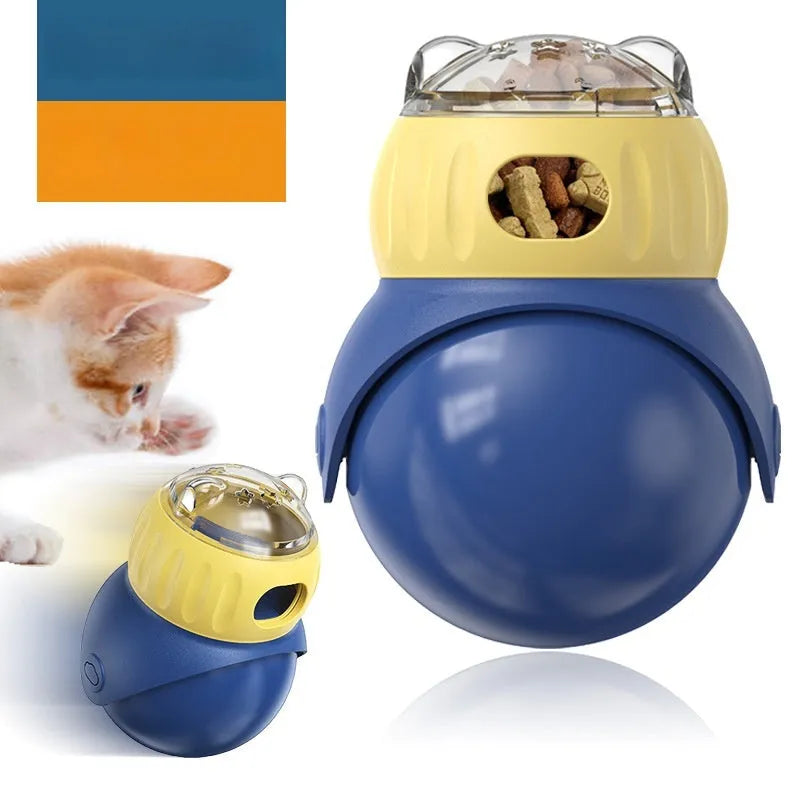 Yellow and blue Tumbler Owl interactive cat feeder toy on a wooden floor