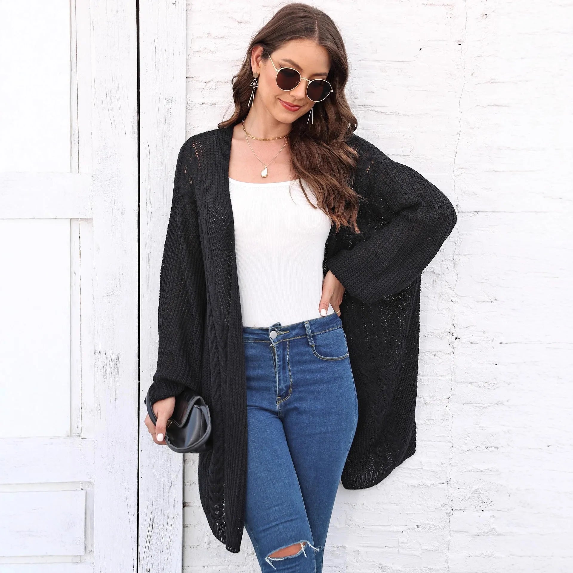 Women's loose longline acrylic cardigan sweater coat in a solid colour.
