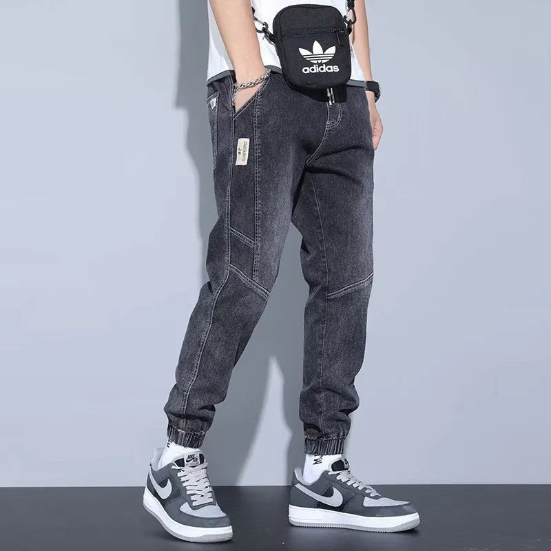 Men's slim fit straight-leg jeans in blue denim with high waist and ankle-tied style