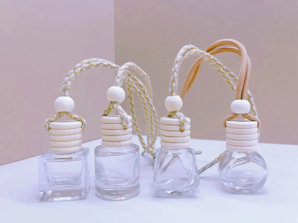 Car air vent perfume pendant showing cylinder, diamond, flat drum, and square glass bottle designs