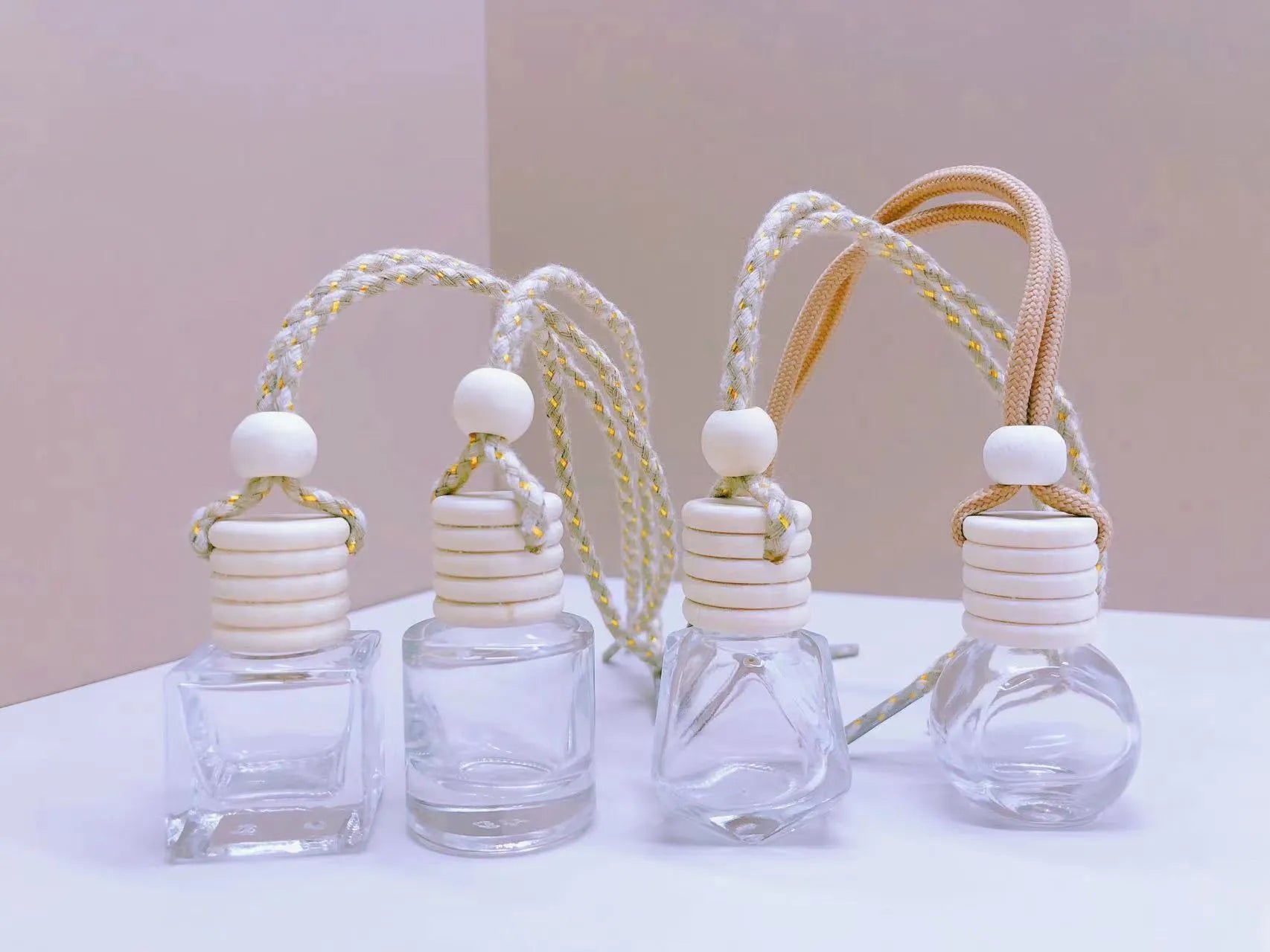Car air vent perfume pendant showing cylinder, diamond, flat drum, and square glass bottle designs