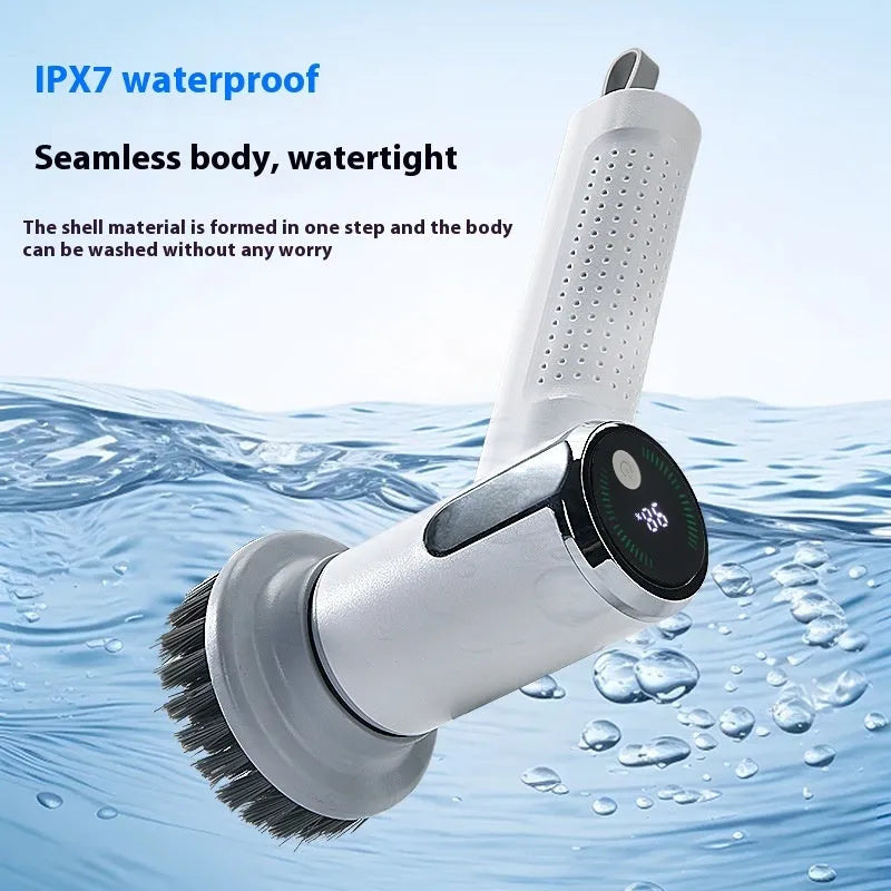 White cordless electric cleaning brush with interchangeable heads on a kitchen counter.