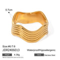 Stainless steel geometric wave ring with wide band and electroplated finish.