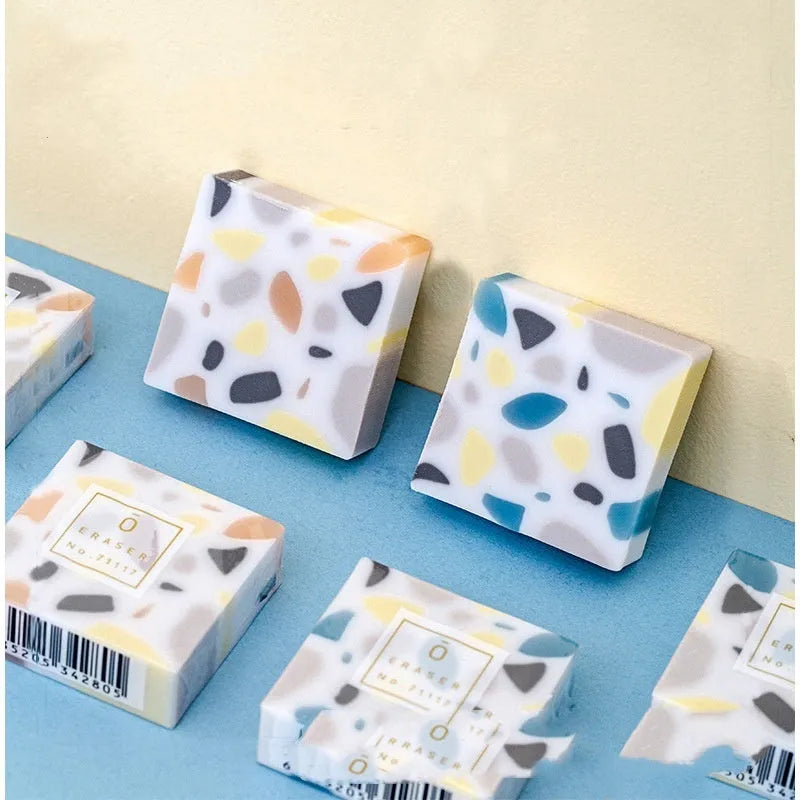 A white brick-shaped soft rubber eraser for traceless pencil correction.