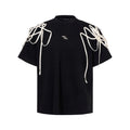 Black loose fit T-shirt with padded shoulders featuring rivet ribbon detailing, short sleeves and round neck collar