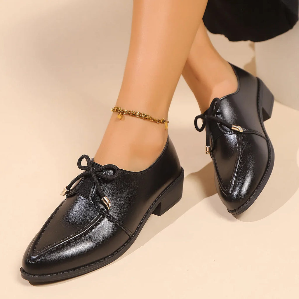 Women's British-style loafers with a bow detail on a PU upper and rubber sole.