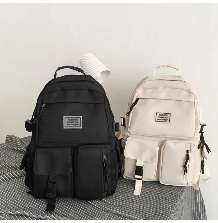 Black or white nylon student backpack with computer compartment and three-dimensional pockets
