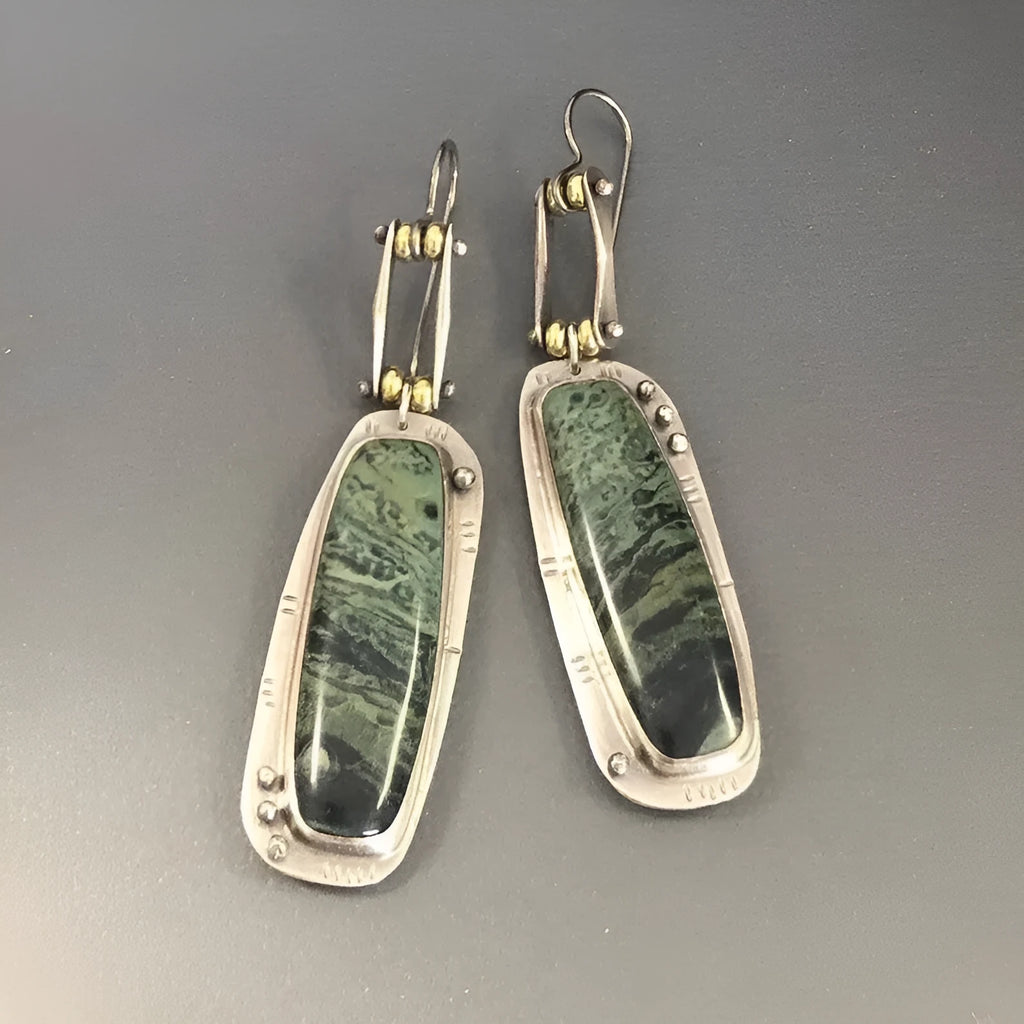 A pair of geometric drop earrings with a white and grey marble pattern on an alloy background.