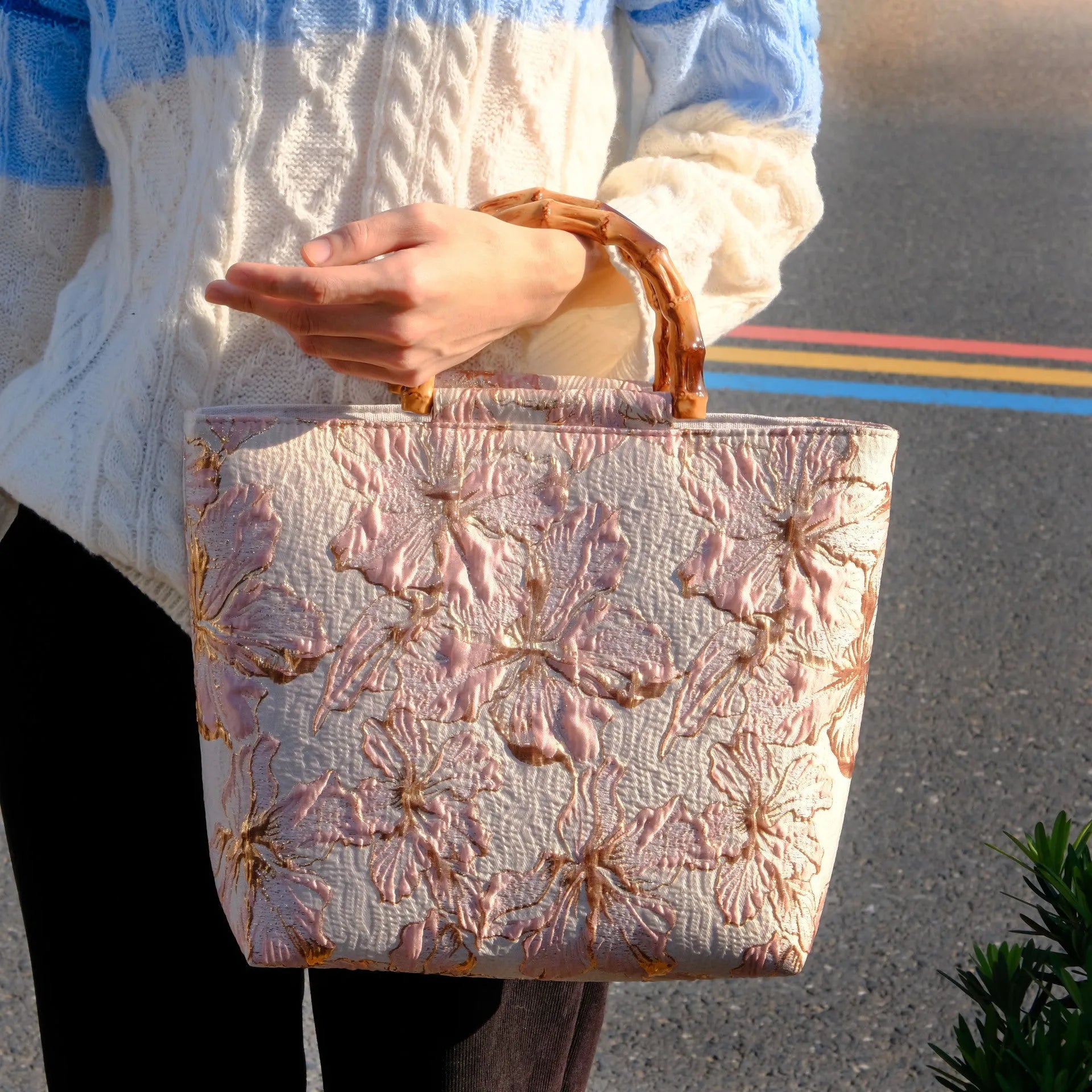 Light blue canvas shoulder bag with bronzing flower pattern, showing square shape and double shoulder straps