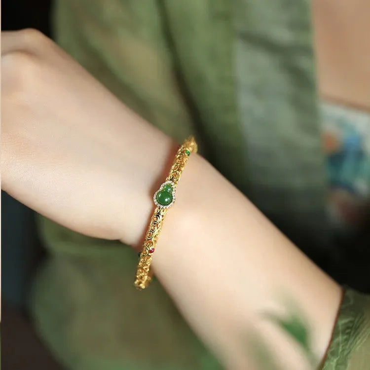 Gold-plated open back women's bracelet with traditional Chinese gourd charm on copper construction
