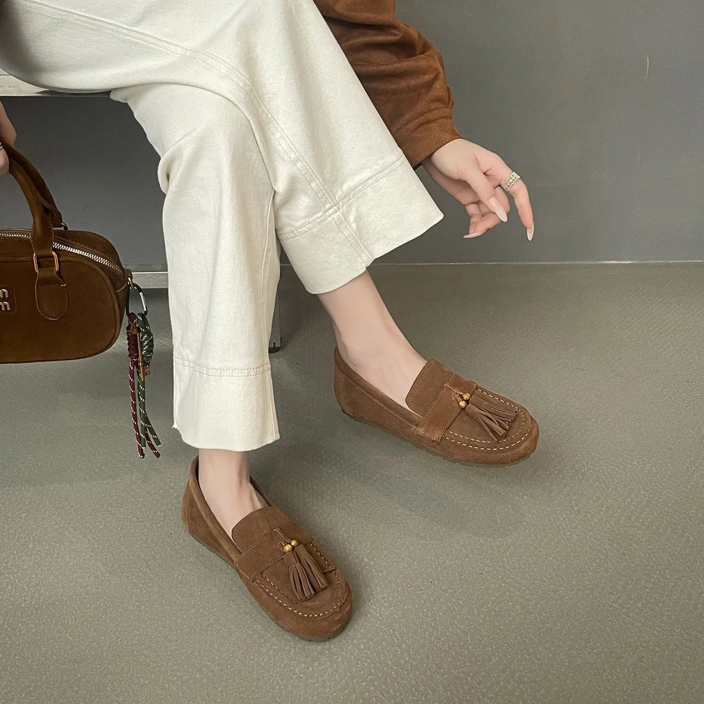 Women's inner height increasing slip-on tassel flats in brown with suede leather upper and round toe
