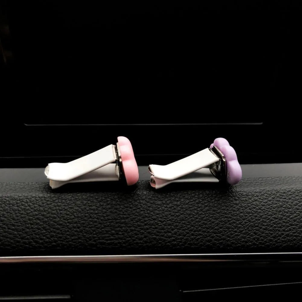 Resin Baiyun cartoon car fragrance clip for air vents in assorted colours.