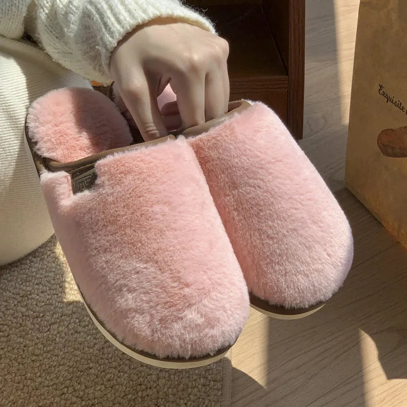 Solid colour plush slippers with PVC non-slip sole and car stitching detail on the upper.