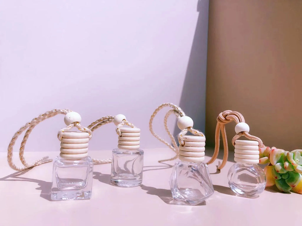 Car air vent perfume pendant showing cylinder, diamond, flat drum, and square glass bottle designs