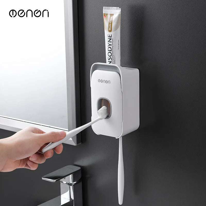 Blue, grey, and pink automatic toothpaste dispenser made of ABS plastic for wall mounting